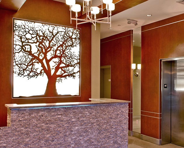 A large tree in the middle of a lobby.