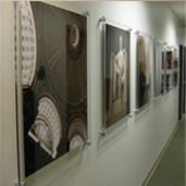 A hallway with several pictures hanging on the wall.