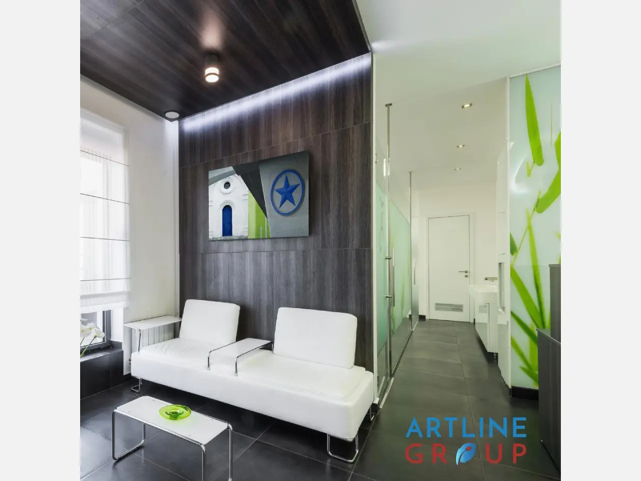Modern living room with white sofa and glass partition.