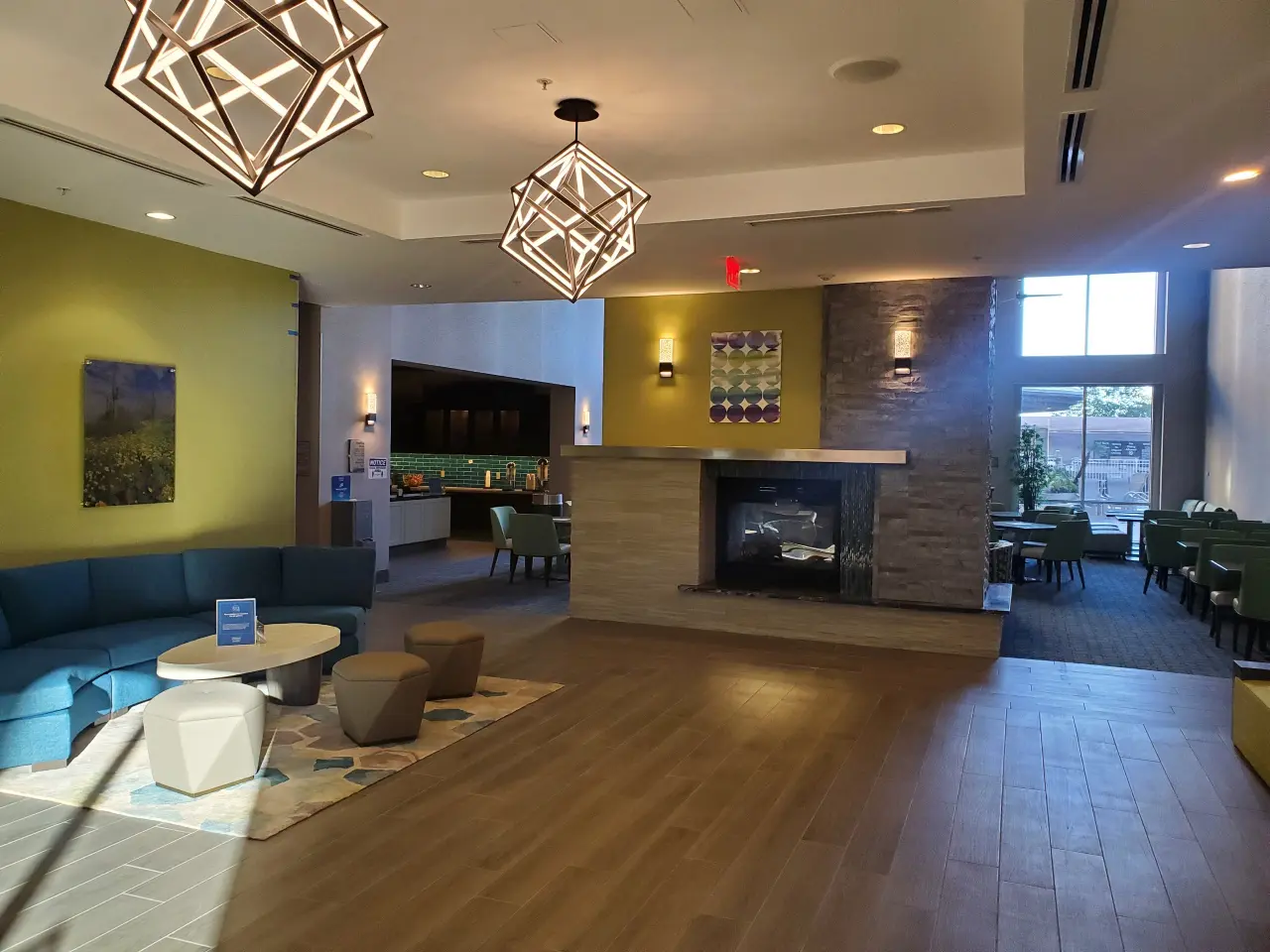 Modern living room with fireplace and geometric light fixtures.