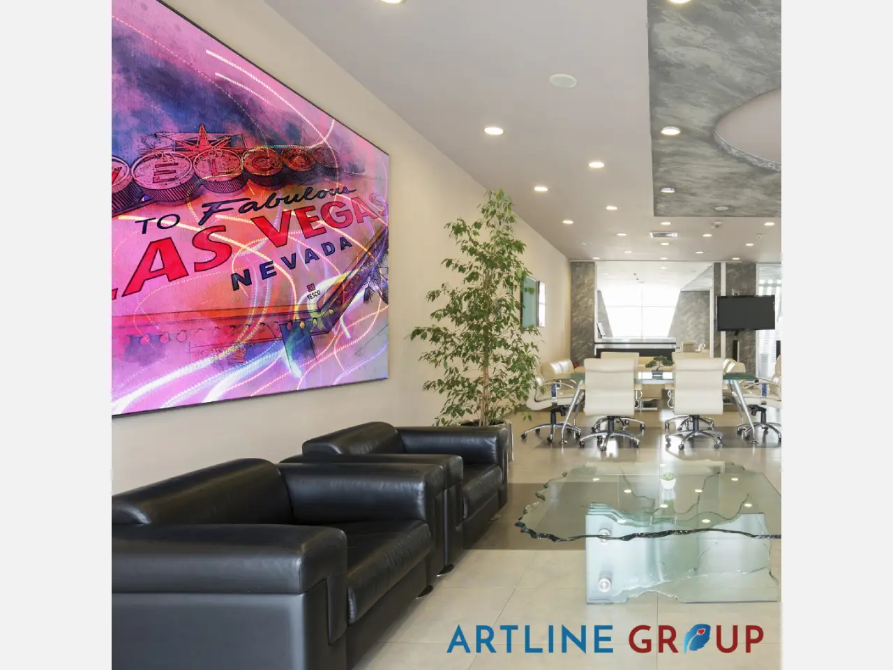 Modern office lobby with black sofas and colorful wall art.